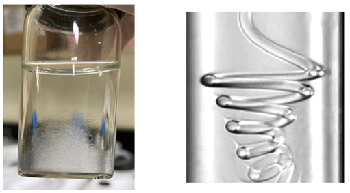 Left: Approximately 5,000 microfibers are collected in the container.
Right: Coiling of a nonuniform microfiber with axially varied elastic modulus. As the fiber coils in the microfluidic device, it forms a spiral with a varying coiling radius that reflects the local elastic modulus. The higher the local elastic modulus, the larger the coiling radius of that segment. (Pictures are reproduced under the terms of the CC-BY license.) [Proc. Natl. Acad. Sci. U.S.A. 121, e2303679121, 2024]